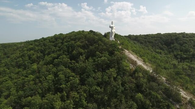 Svyatogorsk Ukraine. View from a drone to the Artyom monument over green trees