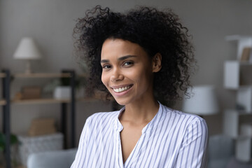 Pretty lady. Portrait of attractive smiling young afro american female at home. Head shot of beautiful millennial mixed race woman in casual look at camera demonstrate pearly white even teeth in smile - Powered by Adobe