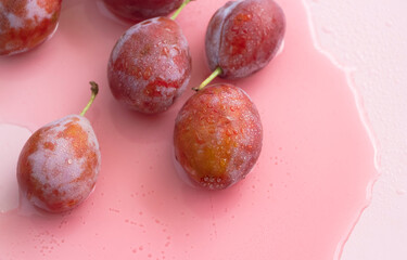 Plums with water drops on peels,