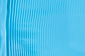Fototapeta na wymiar Abstract background of blue water under sunlight. Top view, flat lay