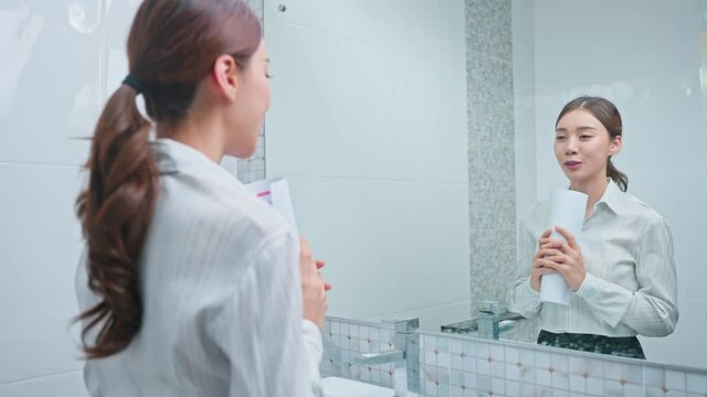 Asian applicant prepare for job interview in front of mirror at home.