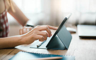 Focus on hand young asian woman touching on digital tablet while she work or meeting online....