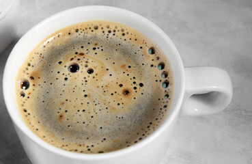 white cup of black coffee from above. top view of coffee bubble close up. caffeine bubble isolated, morning coffee background