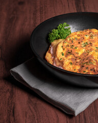 ham and cheese omelet in the pan