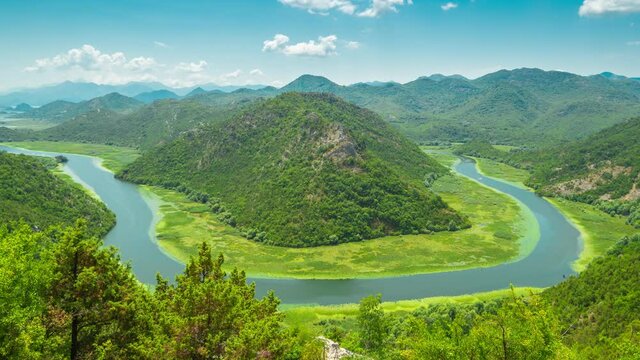 Canyon of Rijeka Crnojevica river near the Skadar lake coast. One of the most famous views of Montenegro. River makes a turn between the mountains and flows backward. Timelapse 4K