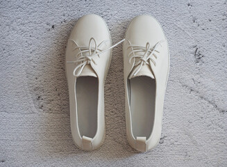 White sneakers on a concrete table. City Style