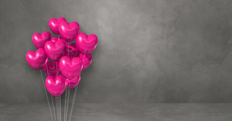 Pink heart shape balloons bunch on a grey wall background. Horizontal banner.