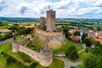 Ruin of medieval Münzenberg castle in Hesse, Germany. Built in12th century, one of the best preserved castles from the High Middle Ages in Germany. Summer, aerial view - obrazy, fototapety, plakaty