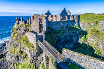 Ruins of medieval Dunluce Castle on a steep cliff. Northern coast of County Antrim, Northern...