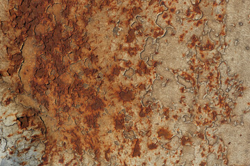 closeup of a rusty metal surface with  beige, yellow, red and orange tones - worn and weathered irregular background with scratches	and peeling painting