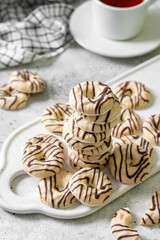 Cookies in white-black chocolate glaze on a light background