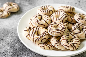 Cookies in white-black chocolate glaze on a light background	