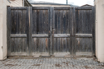Old wooden gate with a large round metal handles