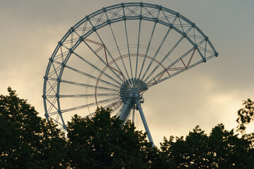 Unfinished ferris wheel in the Moscow public park in the sunset. Modern future amusement concept.