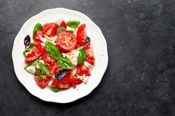 Caprese salad with fresh tomatoes, garden basil and mozzarella cheese