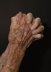 hands of an old woman praying