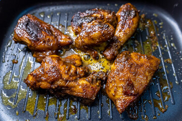 Indonesian Traditional Chicken Grilled on Top of Skillet