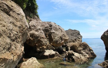 Fototapeta na wymiar Big volcanic rocks in Sinandigan beach, diving spot in Puerto Galera, Oriental Mindoro