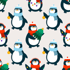 Penguins with Christmas tree, garland, and ball.