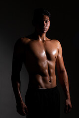 Fototapeta na wymiar Latin and muscular man posing shirtless. strong and dark skinned man.