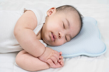 Sleeping baby, selective focus portrait of charming newborn  on comfortable bed