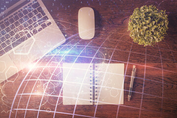 Double exposure of map hologram drawing over study table background with computer. Concept of international network. Top view.