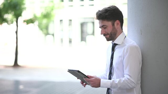Young manager using a digital tablet outdoor