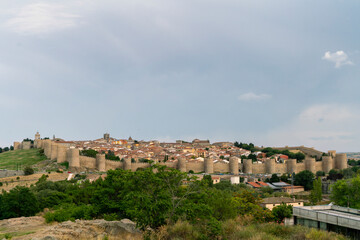 Fototapeta na wymiar Panoramic view of the historic city of Avila, Spain, with its famous medieval walls surrounding the city at sunset. Called City of Stones and Saints