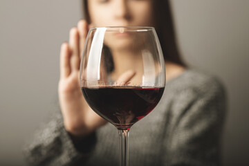 reject liquor,stop alcohol, teenager girl shows a sign of refusal of wine - obrazy, fototapety, plakaty