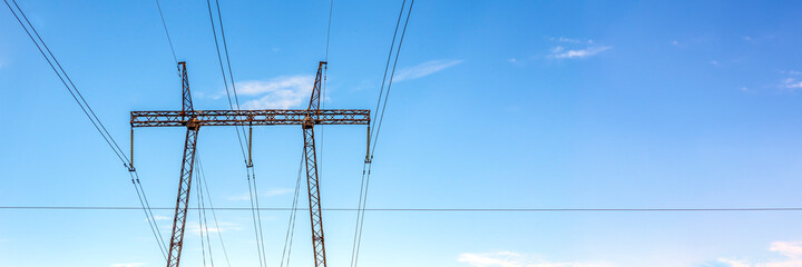 High voltage pillar. Power grid pole against the sky. High voltage tower. Electricity use and electricity cost concept. Panoramic photo