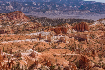 Wide angle view of the distant valley outside the orange sandstone of Bryce Canyon