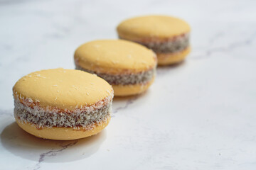 Traditional Argentinian alfajores with dulce de leche on marble table. Argentine gastronomy concept.