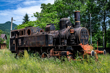 Fototapeta na wymiar The old steam locomotive is parked in a depot in Petrosani, Romania