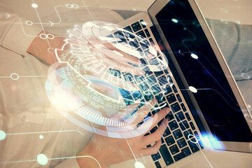Double exposure of woman hands working on computer and data theme hologram drawing. Top View....