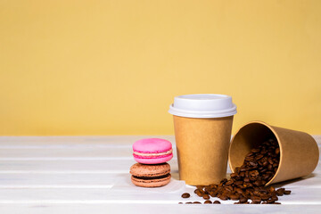 Take away Coffee in paper eco cup with french macaroon on wooden and light orange background, Fast food, Copyspace, Caffeine Drink take away, Bean