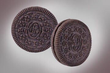 Chocolate cookies with milk cream on dark background.  Collection of chocolate sandwich cookies 