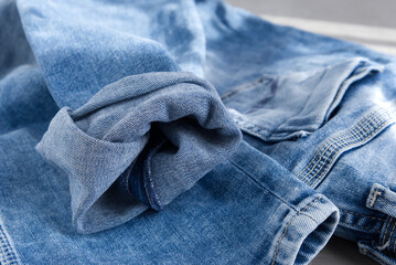 a blue light jeans on a grey background. Close up. 
