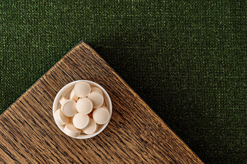 glutathione complex supplement pills on a wooden desk. dietary supplements top view. mental wellbeing and personal health concept