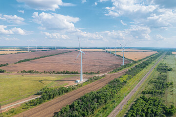 Fototapeta na wymiar Aerial view of Wind power turbine is a popular sustainable, renewable energy source on beautiful cloudy sky. Wind power turbines generating clean renewable energy for sustainable development.