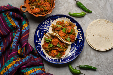 Mexican food. Chorizo and nopales tacos on grey background