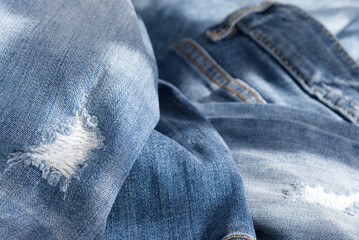 background of blue crumpled ripped jeans. Close up 