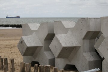 big concrete xblocs at the beach of the westerschelde sea at the dutch coast in cadzand