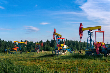 Fototapeta na wymiar oil pumping stations pumpjacks in a clearing in the forest