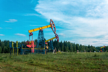 Fototapeta na wymiar oil pumpjacks in a clearing in the forest