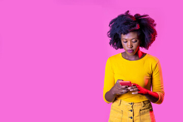 Isolated black young woman using smartphone watching video surfing web on advertising copyspace background