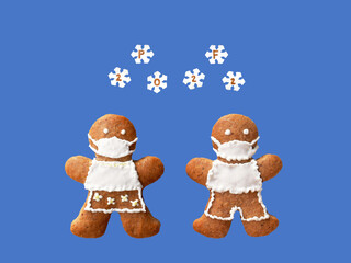 PF 2022 inscribed in snowflakes falling on gingerbread couple with protective face masks. Original...