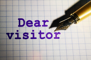 Fototapeta premium There is a pen on the notebook, near which it is written Dear visitor