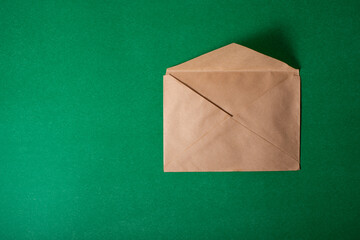 Vintage paper envelope on a green background.