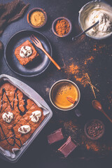 Homemade brownies with cup of coffee and baking ingredients