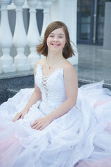 Girl with Down syndrome in  wedding dress.